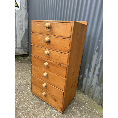 212 - A country pine chest of seven drawers 60 x40x108