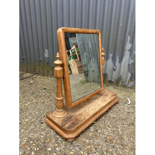 215 - A Victorian pine swing mirror