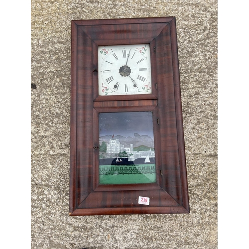 238 - A mahogany American wall clock with pendulum and weights