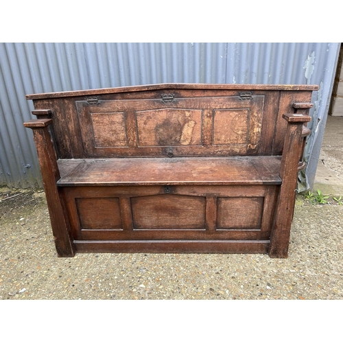 47 - An unusual early 20th Century oak settle bench with folding buffet style shelf 166cm wide