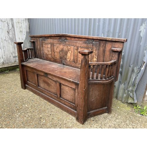 47 - An unusual early 20th Century oak settle bench with folding buffet style shelf 166cm wide