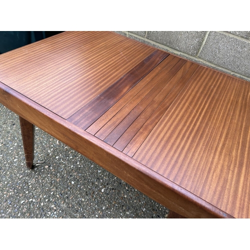 68 - A mid century teak dining table with roller style extension mechanism 107x77x77