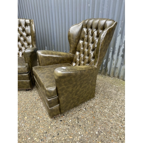 72 - A pair of bottle green leather chesterfield armchairs