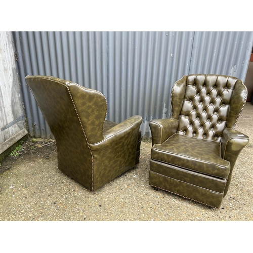 72 - A pair of bottle green leather chesterfield armchairs
