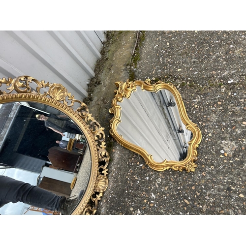 8 - An ornate circular gilt framed mirror together with a other gold framed mirror
