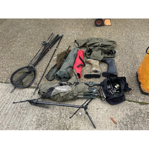 85 - A collection of fishing nets, rods, reels, bags, boots etc