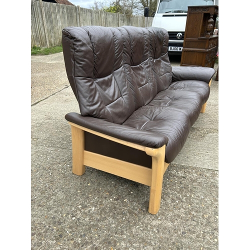 88 - A STRESSLESS brown leather three seater reclining sofa by EKORNES