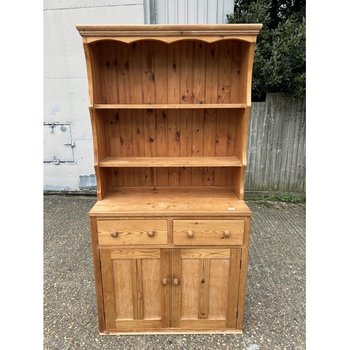 97 - A country pine dresser with plate rack top over two drawer base 102x 48x200