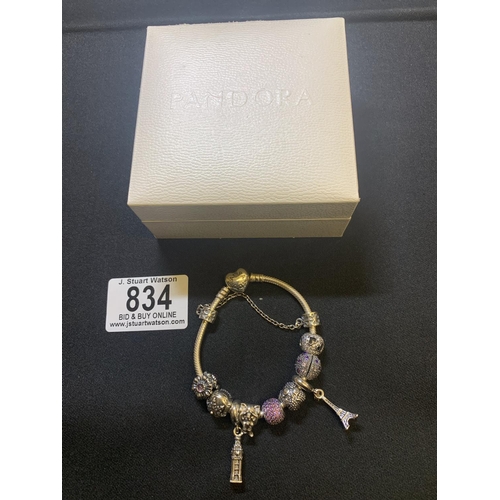 834 - A boxed Pandora bracelet with 6 beads and 3 charms