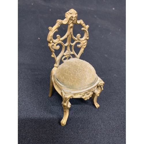 825 - Miniature gilt brass pin cushion chair, jade pendant and other items