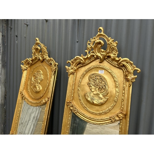 280L - A pair of decorative gold gilt framed halfway mirrors with ladies facing one another 160cm tall