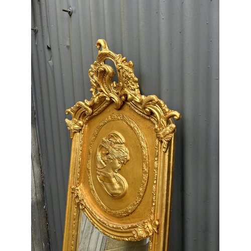 280L - A pair of decorative gold gilt framed halfway mirrors with ladies facing one another 160cm tall