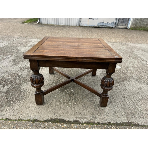 1 - A large oak drawer leaf dining table 106x106x77