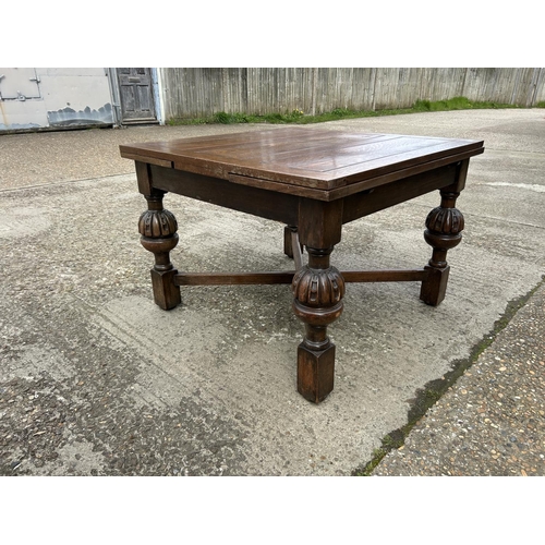 1 - A large oak drawer leaf dining table 106x106x77