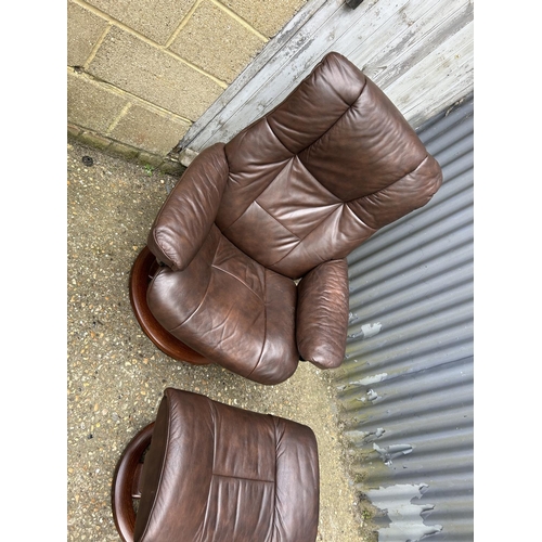 100 - A pair of EKORNES brown leather stressless recliner chairs with matching stools