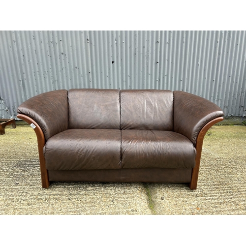 101 - An ekornes brown leather two seater sofa