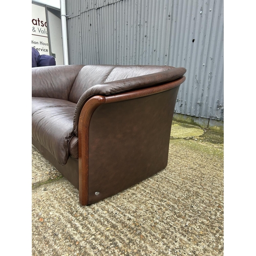 101 - An ekornes brown leather two seater sofa