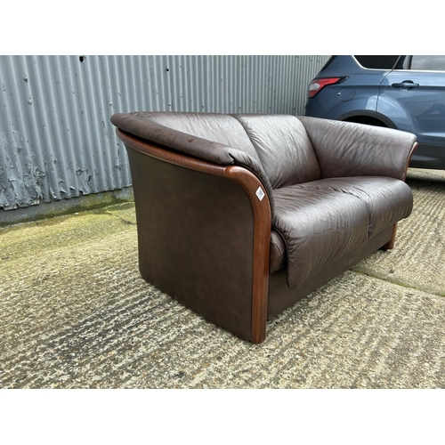 101 - An ekornes brown leather two seater sofa