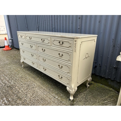 129 - A french style white and gold gilt chest of nine drawers 143x44x77