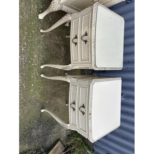 133 - A pair of French style white and gold painted three drawer bedsides