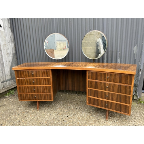 138 - A mid century teak curved kneehole desk / dressing table 191x50x77