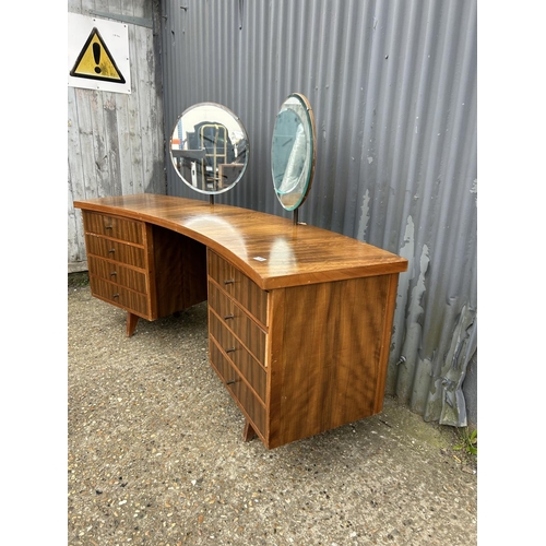 138 - A mid century teak curved kneehole desk / dressing table 191x50x77