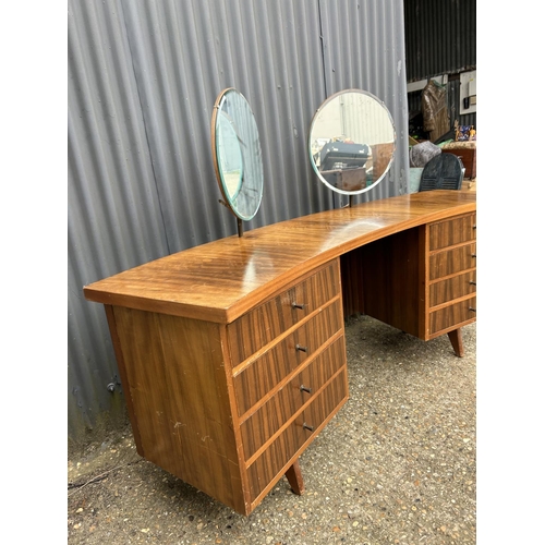 138 - A mid century teak curved kneehole desk / dressing table 191x50x77