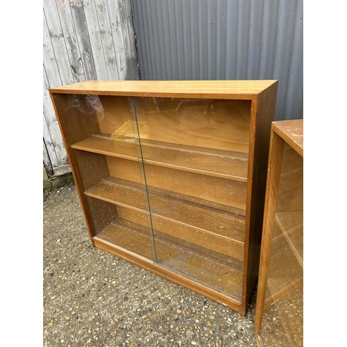 139 - Two mid century glazed bookcases with sliding doors  90x23x90