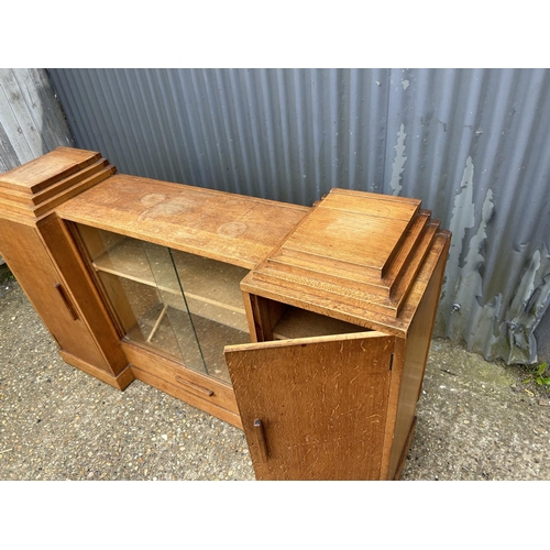 141 - A deco style light oak bookcase sideboard with keys 154x40x90