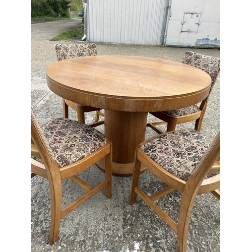 143 - A deco style light oak circular dining table with four chairs 107cm diameter  x 75 high