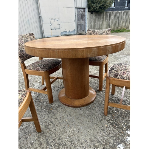 143 - A deco style light oak circular dining table with four chairs 107cm diameter  x 75 high