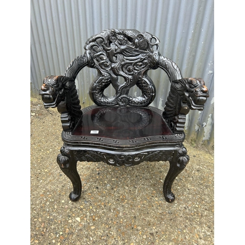 146 - A carved hardwood chair with dragon decoration