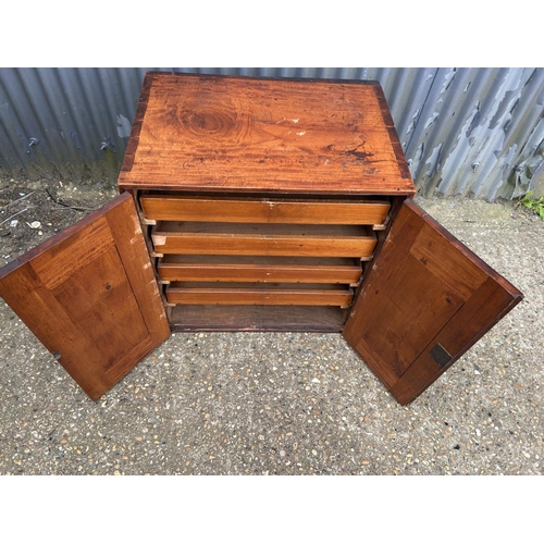 148 - An Edwardian mahogany two door artists cabinet with four slides 72x50 x27