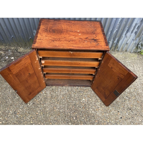 148 - An Edwardian mahogany two door artists cabinet with four slides 72x50 x27