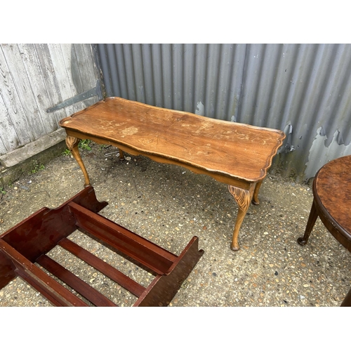 151 - A walnut coffee table, rectangular table and two wall shelves