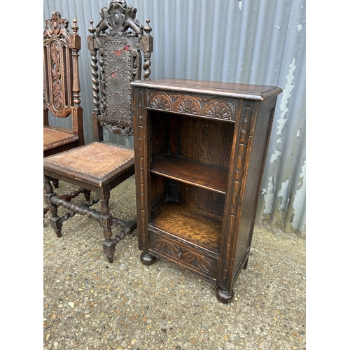 167 - A small carved oak open bookcase with drawer together with two carved oak chairs