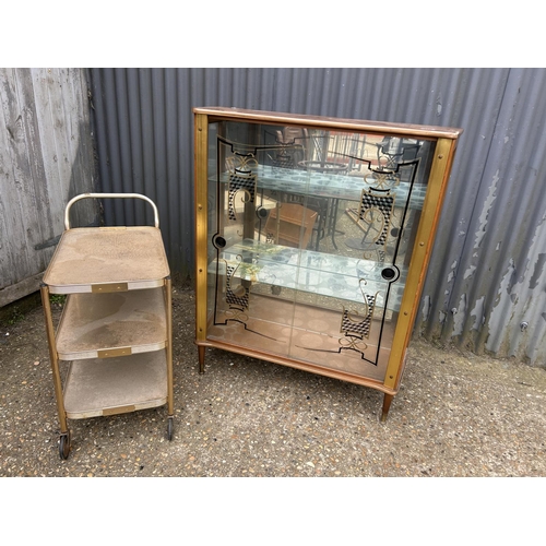 175 - A retro glazed display cabinet together with a aluminium tea trolley