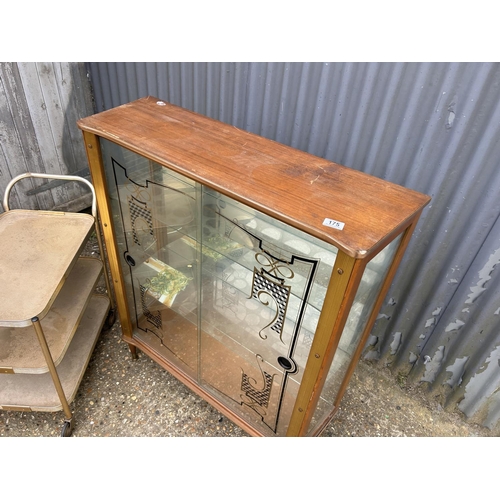 175 - A retro glazed display cabinet together with a aluminium tea trolley