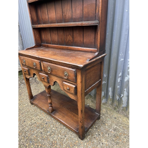 192 - An oak cottage dresser with plate rack top over five drawer base 91x36x164