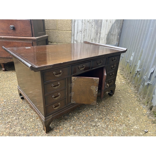 193 - A double sided oriental hardwood coffee table with drawers and doors to each side 90x58x50