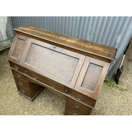 195 - A patent oak station masters desk with drop down front and internal fitment 122x50x120