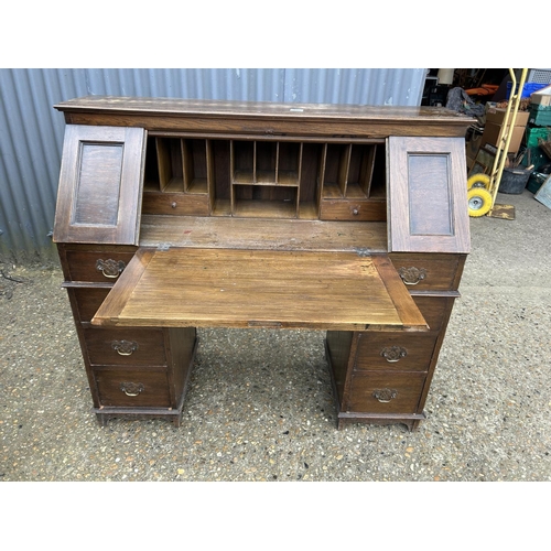 195 - A patent oak station masters desk with drop down front and internal fitment 122x50x120