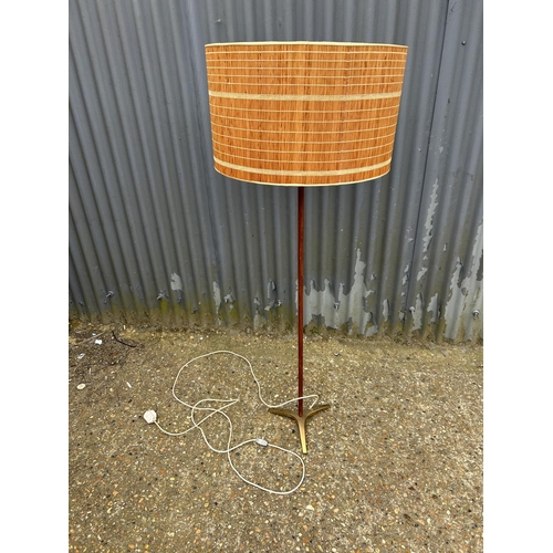 216 - A mid century teak standard lamp with shade