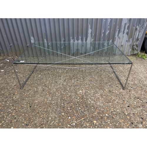 220 - A modern glass and steel coffee table 124x75x36