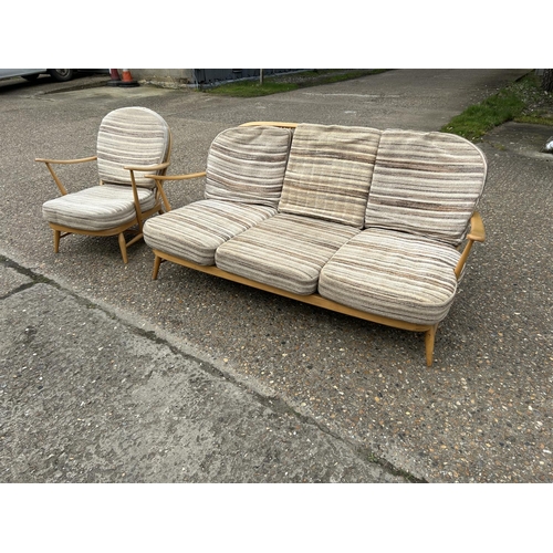 23 - An ercol light elm sofa and armchair