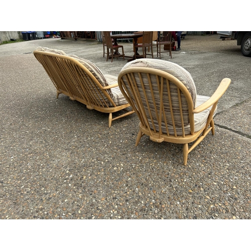 23 - An ercol light elm sofa and armchair