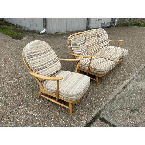 23 - An ercol light elm sofa and armchair