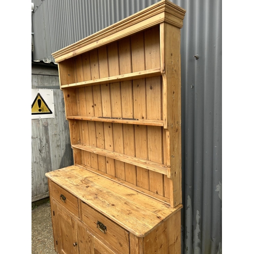 232 - A country pine dresser with plate rack top over two drawer and two door base 138x44x220