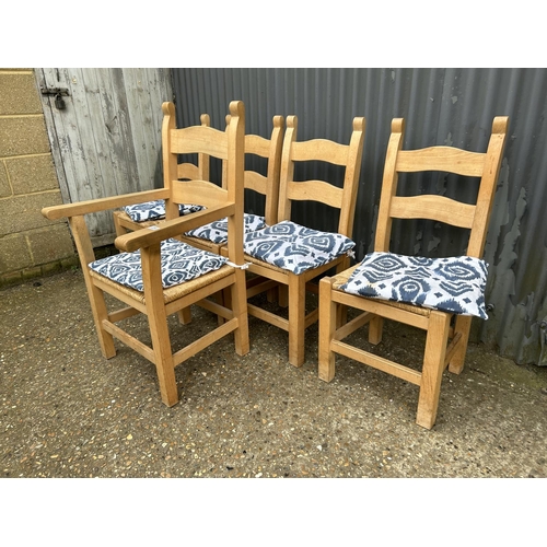 234 - A set of five modern solid pine dining chairs with rush seats