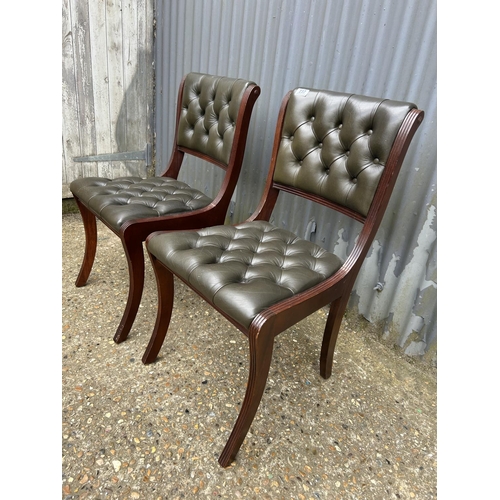 237 - A pair of green leather chesterfield office chairs